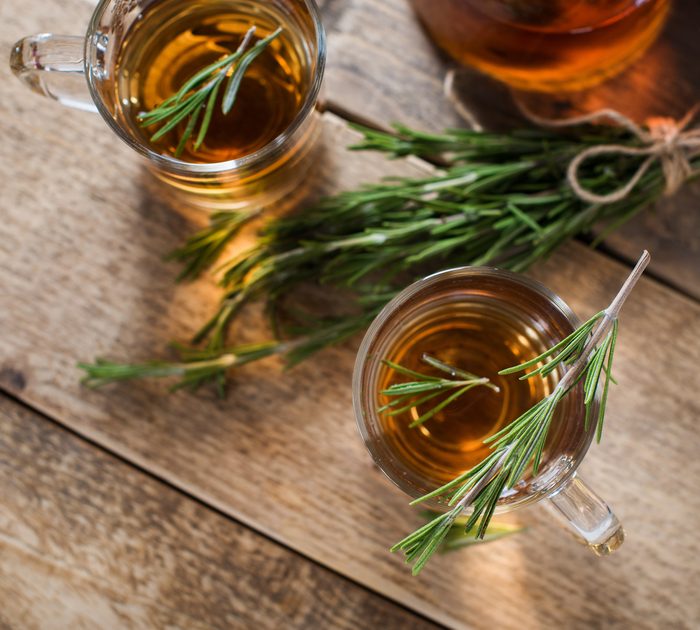 Herbal kombucha tea with aromatic rosemary on wood table