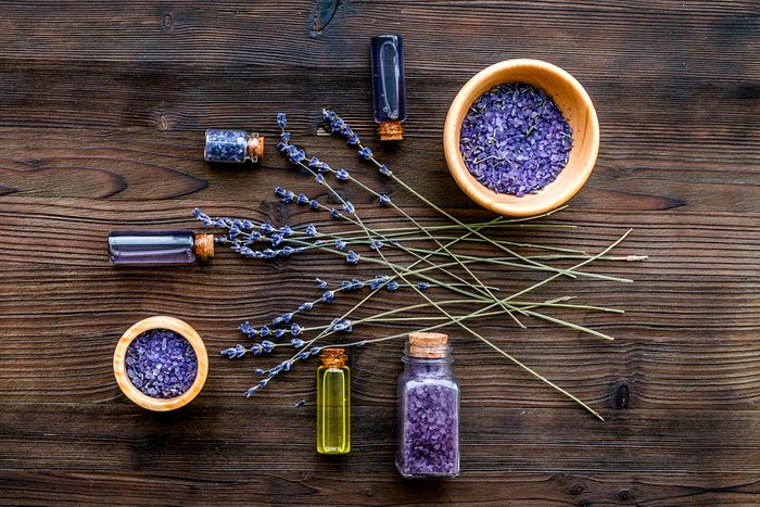 cosmetics with lavender on wooden background top view