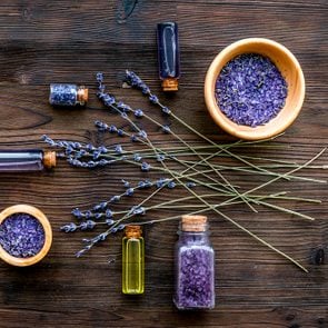 organic cosmetics with lavender on wooden background top view