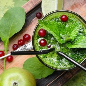 Blended green smoothie drink with spinach and apple