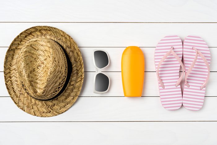 straw hat, sunglasses, sunblock, flipflops