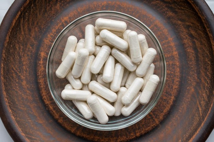 white vitamin capsules in a bowl