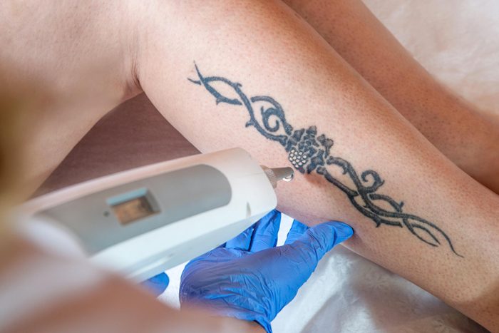 person getting tattoo on leg