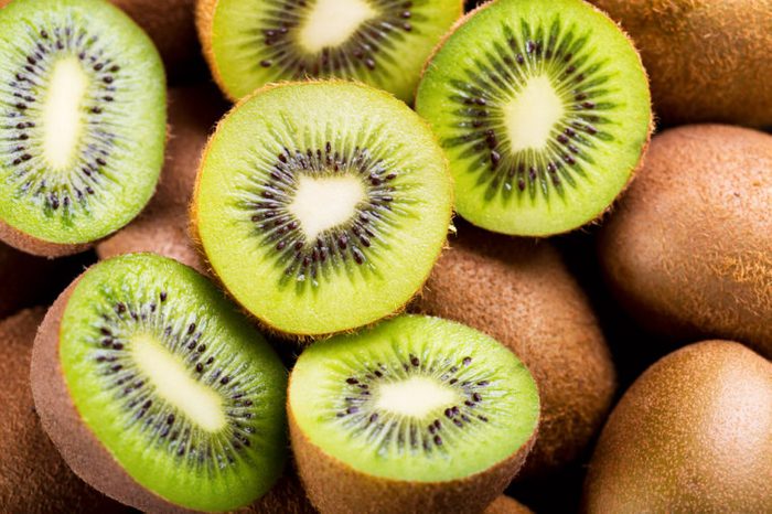 halved and whole green kiwis