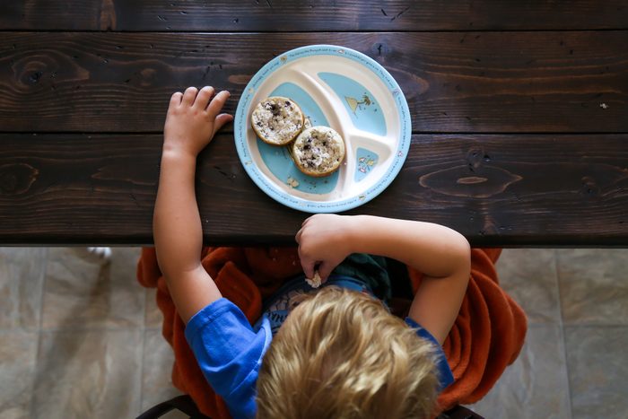 overhead shot of young boy and plate of food