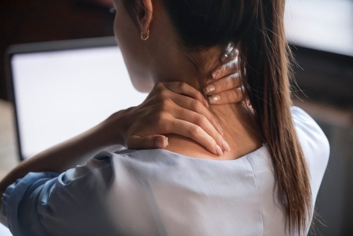 rear view close up of woman with neck pain