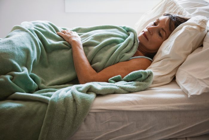 woman lying in bed awake