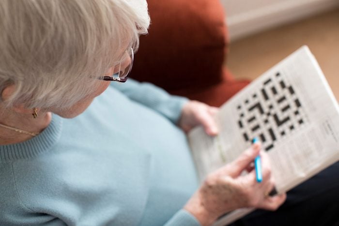 Senior Woman Doing Crossword Puzzle for aging brain