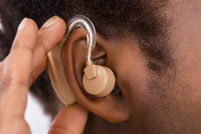 Close-up of woman wearing hearing aid in ear
