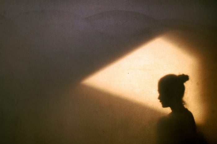 profile of woman in shadow wall
