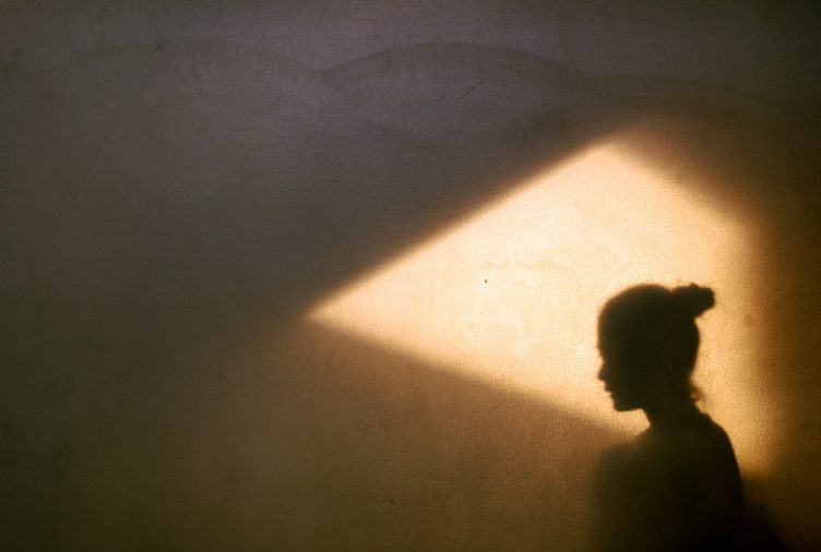 profile of woman in shadow wall