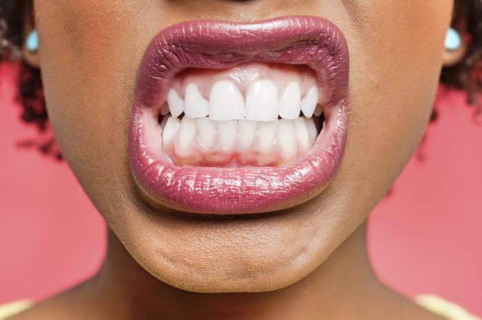 Cropped image of woman clenching teeth