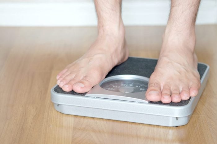 Man standing on scales.