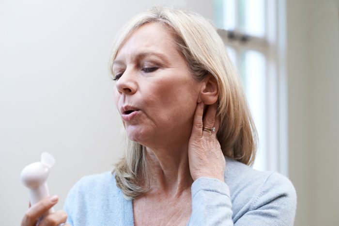 Mature Woman Experiencing Hot Flash From Menopause