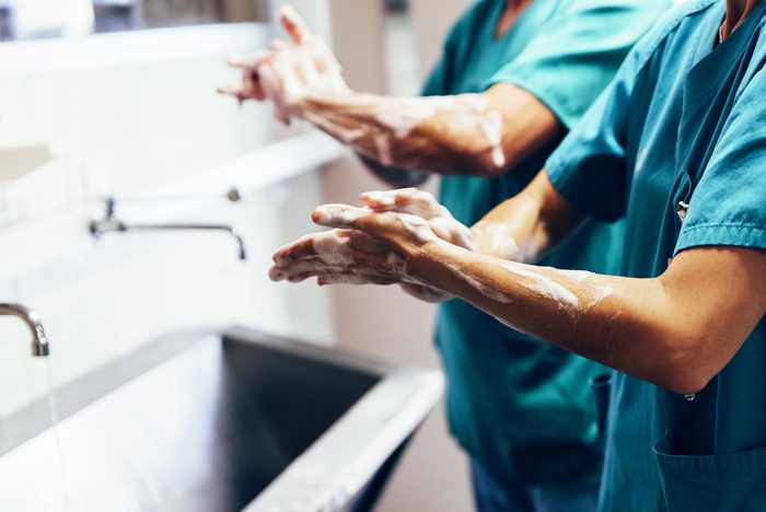 Couple of Surgeons Washing Hands Before Operating. Hospital Concept.