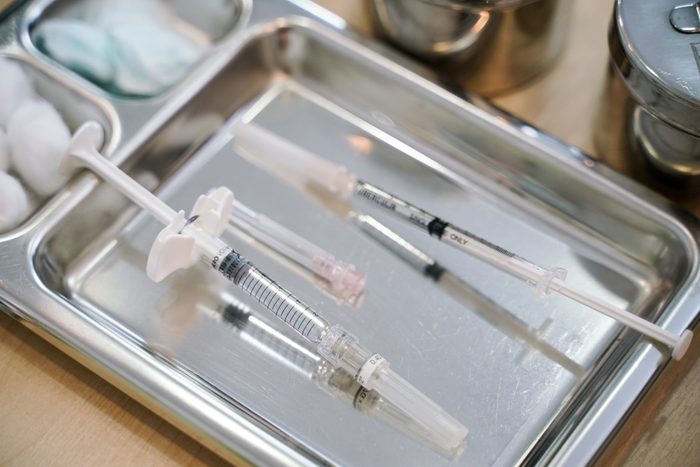 Syringe with needle on a steel tray for a medical vaccine in a hospital