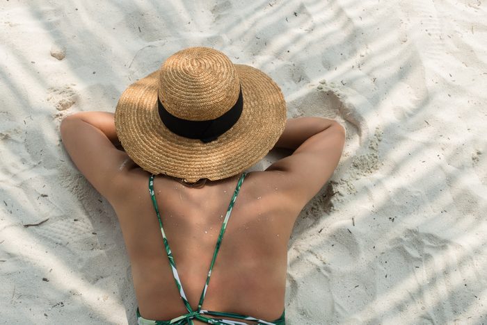 woman lying in sun to get tan