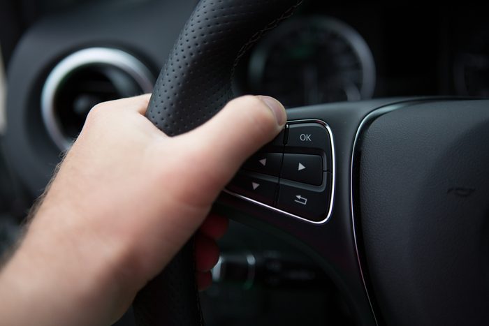 hand close up of a man driving a car