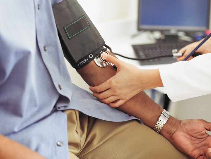 close up of doctor taking patient's blood pressure