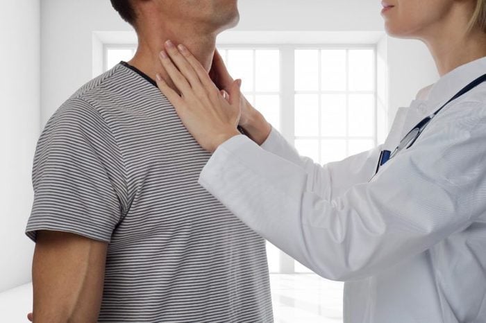 doctor checking man's lymph nodes in neck