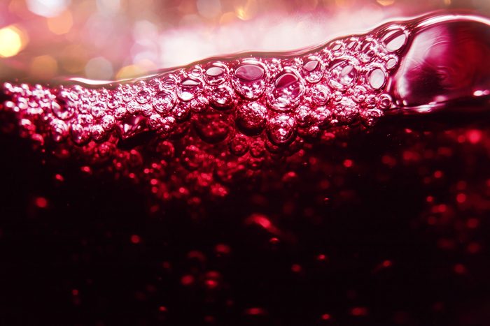 Red wine on a black background, abstract splashing.