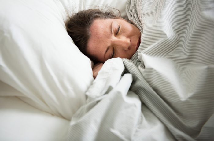Caucasian woman sleeping on bed
