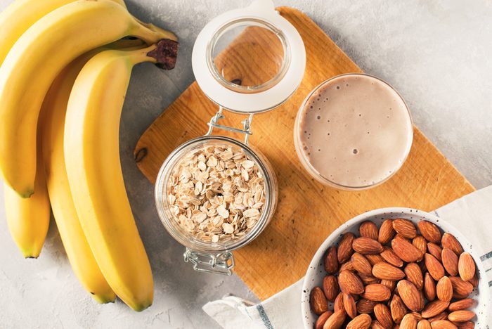 Healthy breakfast banana oatmeal almond milk on white background