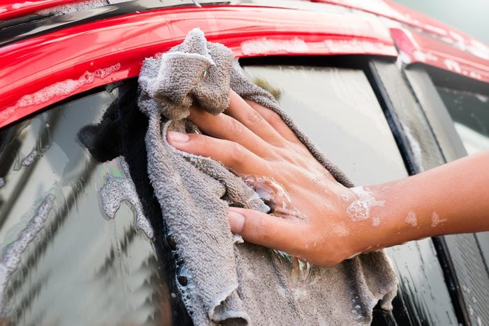 Young man car wash at home