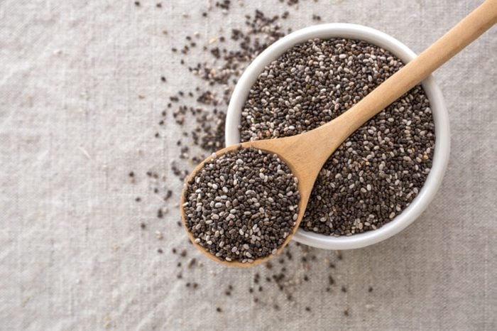 Bowl of chia seeds with a wooden spoon