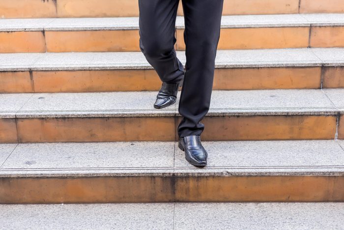 man walking down steps in dress shoes
