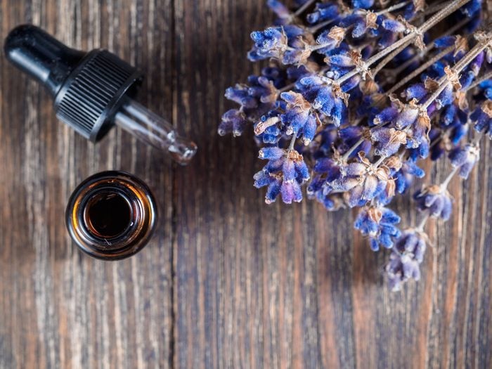 essential oil with pipette and bunch of dry lavender flowers. Top view or flat-lay. Copy space for text.