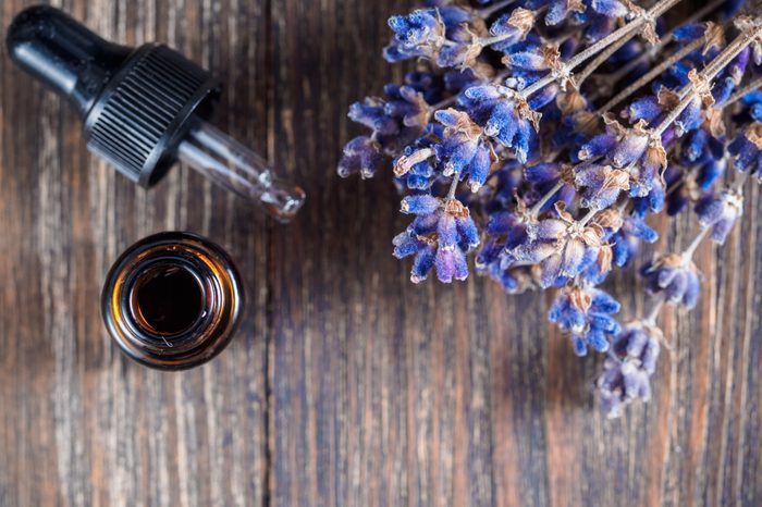 essential oil with pipette and bunch of dry lavender flowers. Top view or flat-lay. Copy space for text.