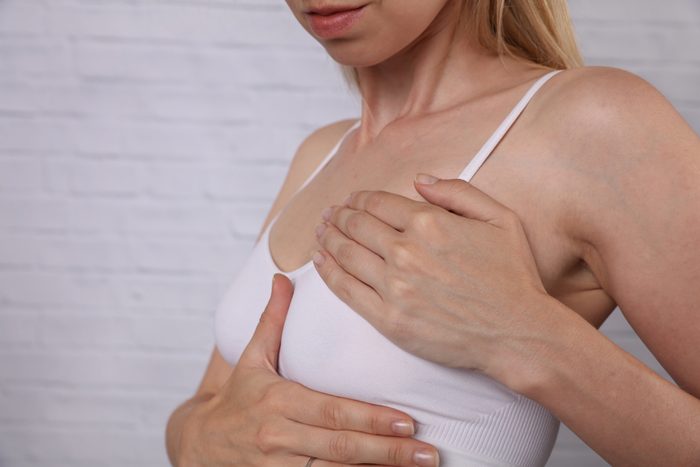 Woman Checking Her Breast, health care and prevention concept