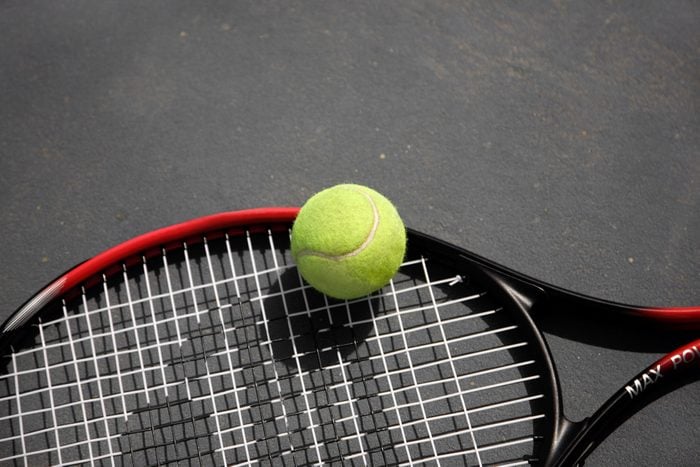 A tennis racket and ball