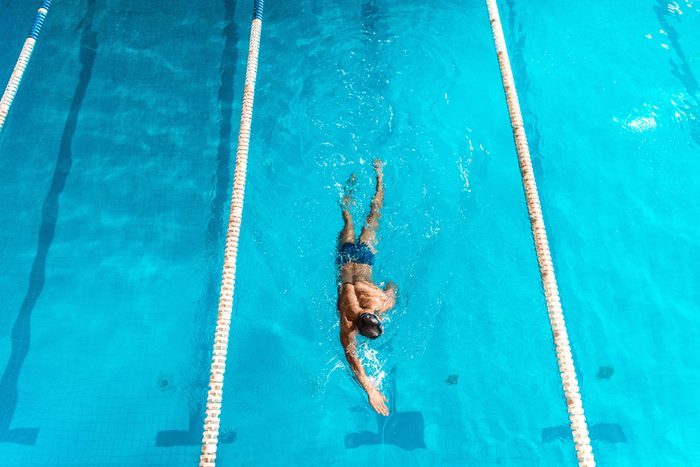 overhead view of swimmer in competition swimming pool with lines