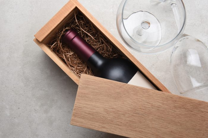 Red Wine Box: A single bottle of Cabernet in a wood box partially covered by its lid with two empty glasses.