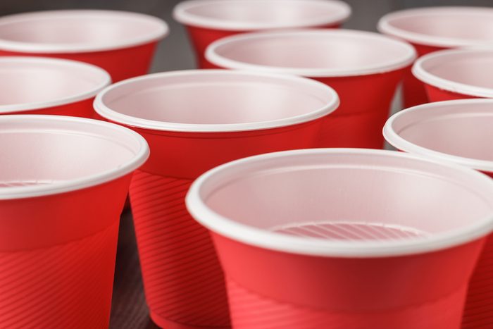 disposable red plastic cups on the wooden table