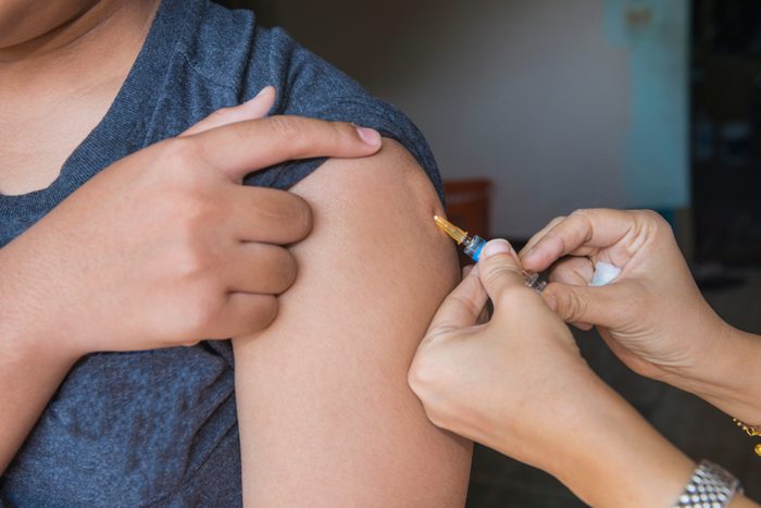 Nurse are vaccinations to patients using the syringe.Doctor vaccinating women in hospital.Are treated by the use of sterile injectable upper arm. Close up injection,antibody,influenza vaccine