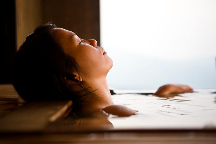 woman taking a bath relaxing and de-stressing