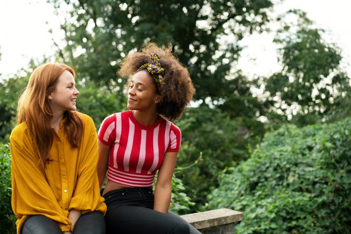 two young women talking outside