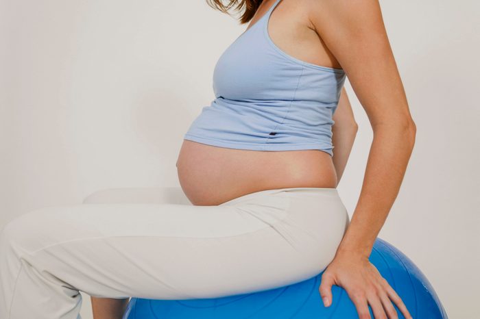 pregnant woman sitting on exercise ball during labor