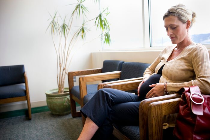 pregnant woman sitting in waiting room