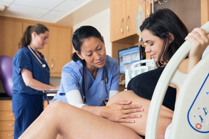 doctor assisting woman in labor