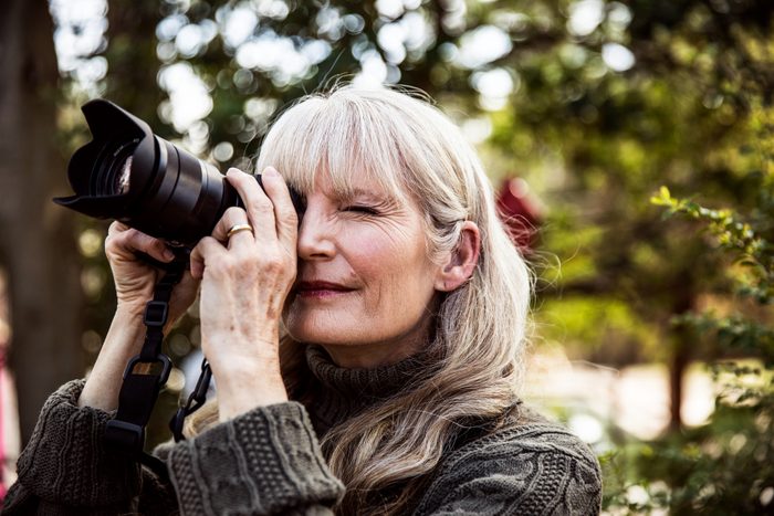 woman enjoying her photography hobby outside in nature