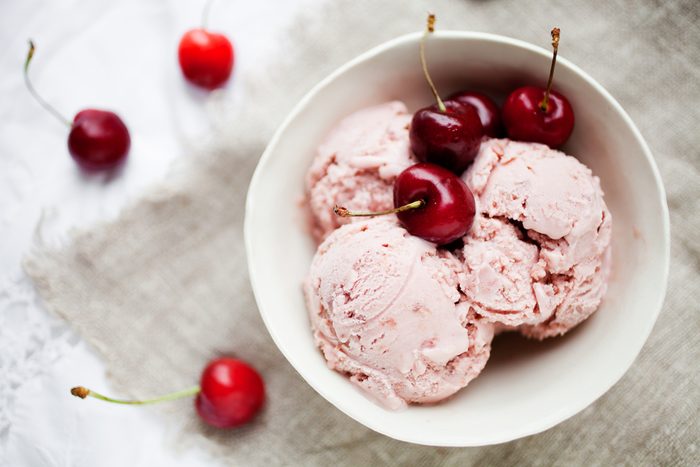 Homemade cherry ice cream on table
