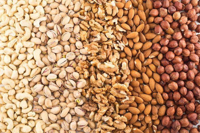 Surface covered with different nut mix of hazelnut, pistachio, peanut, almond, walnut 