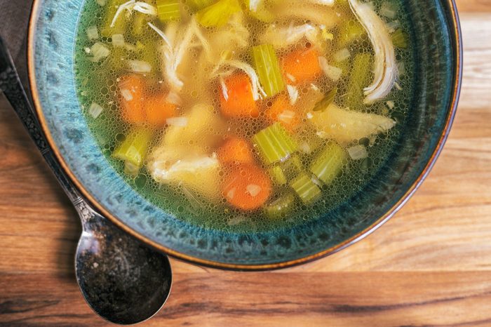 bowl of chicken soup with carrots and celery