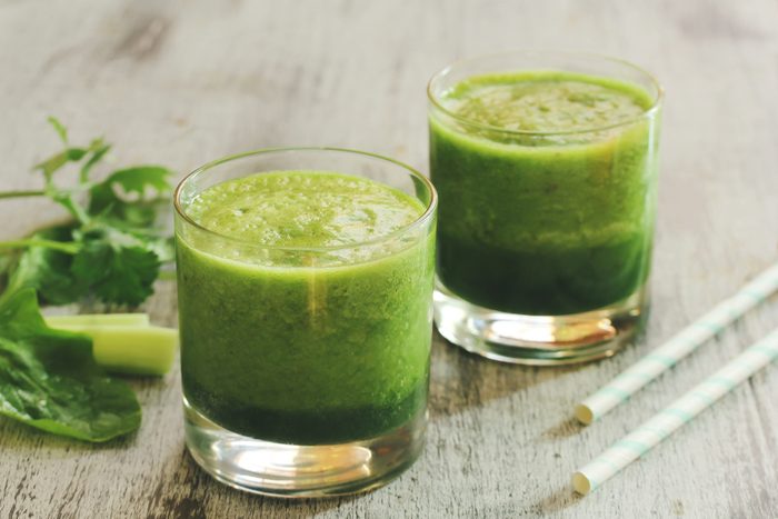 Green Smoothie with spinach celery cilantro, selective focus