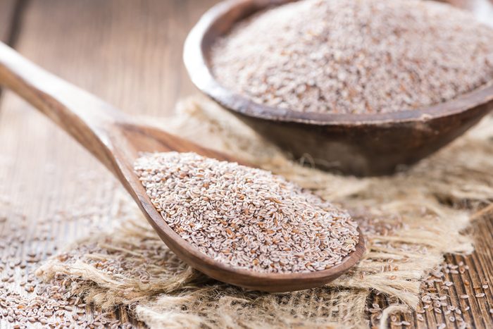 Portion of Psyllium Seeds on rustic wooden background