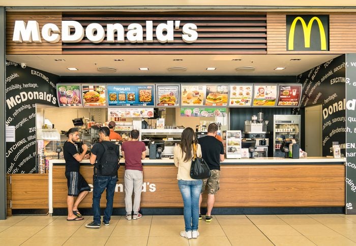RIMINI, ITALY - MAY 30, 2014: people waiting for the food service at Mc Donalds desk in the shopping mall " Le Befane " . The fast food company was founded in 1940 in San Bernardino, California.